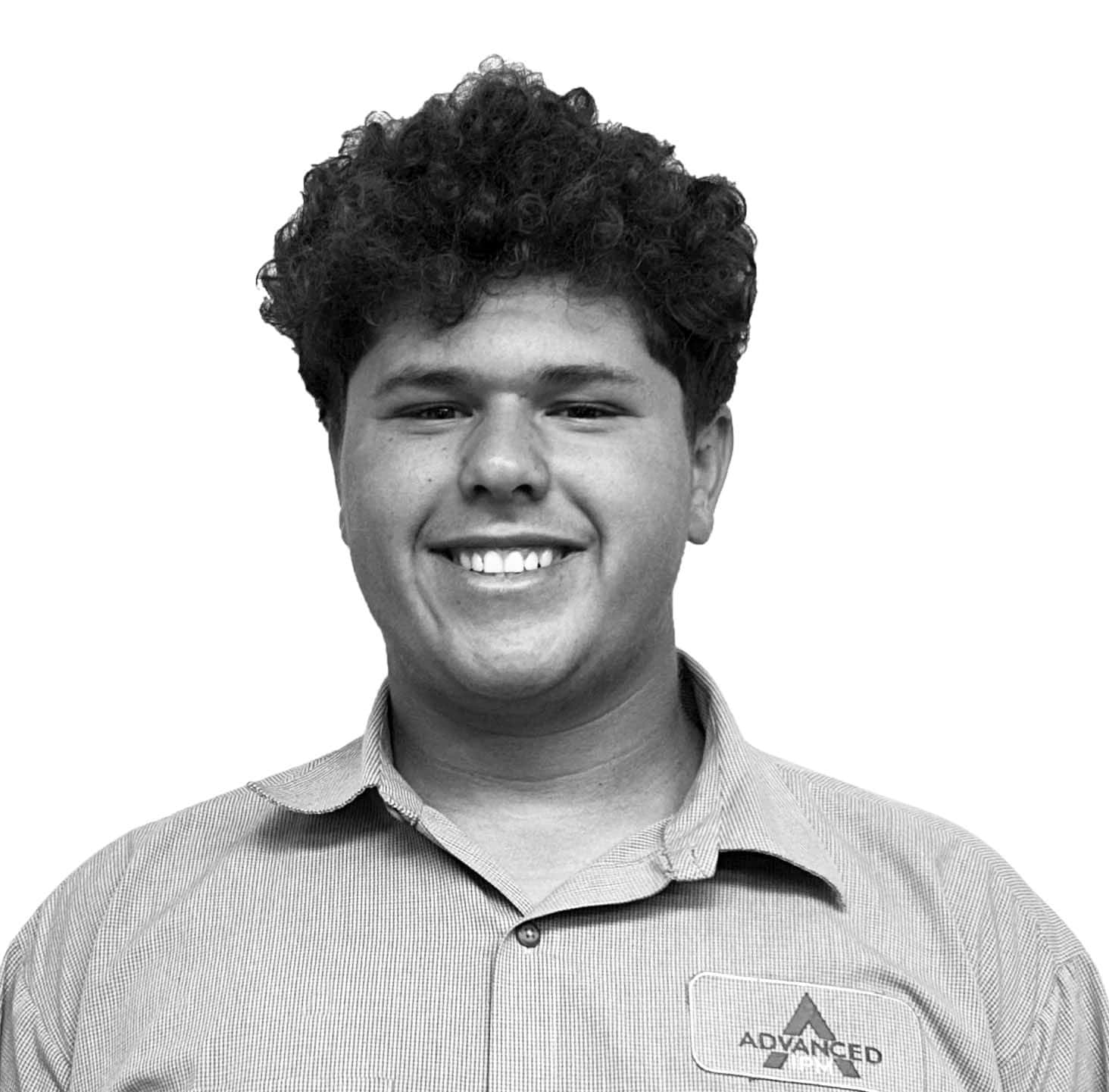 Young man smiling in a professional pest management uniform.