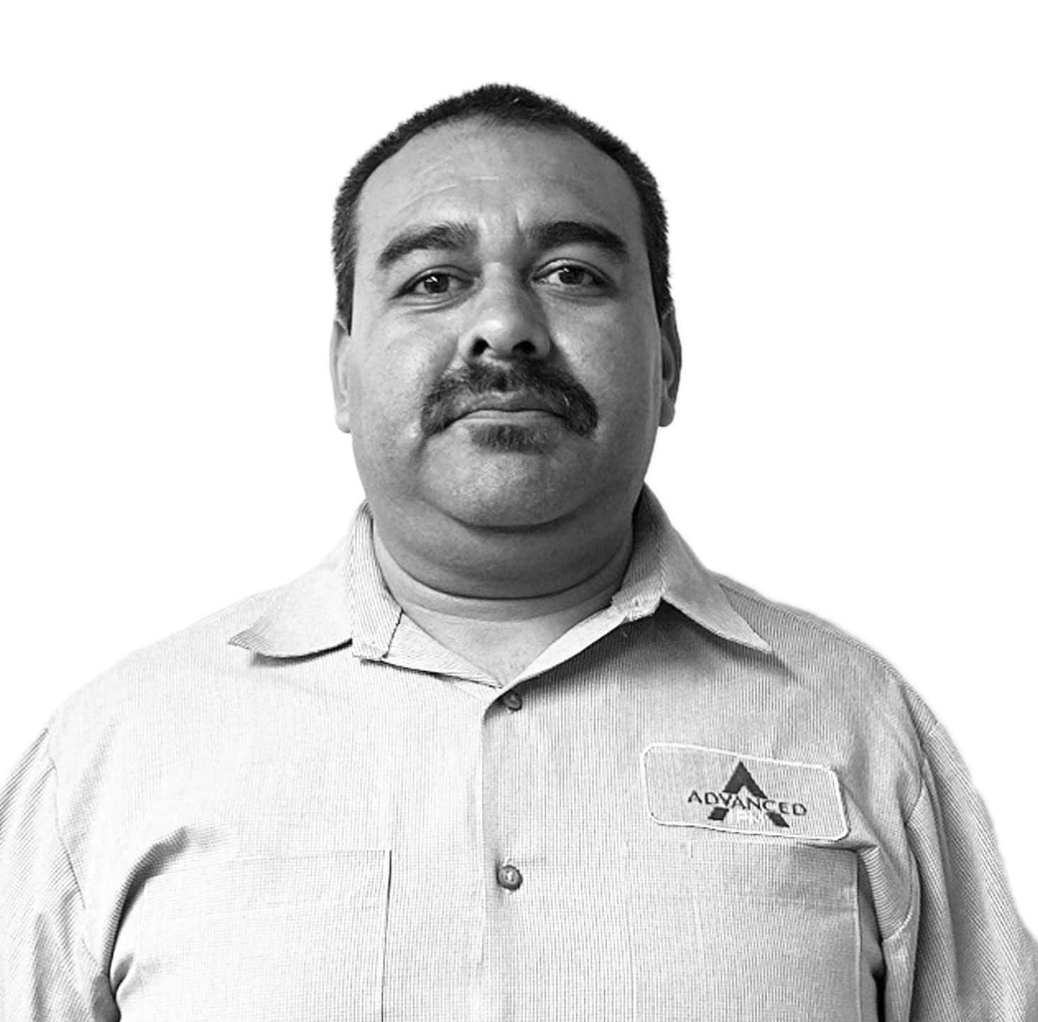 Man in professional attire with pest management logo on shirt.