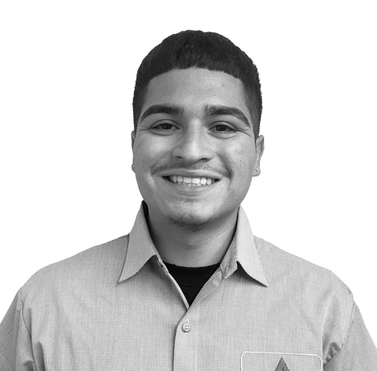 Smiling young man in a collared shirt, black and white photo.
