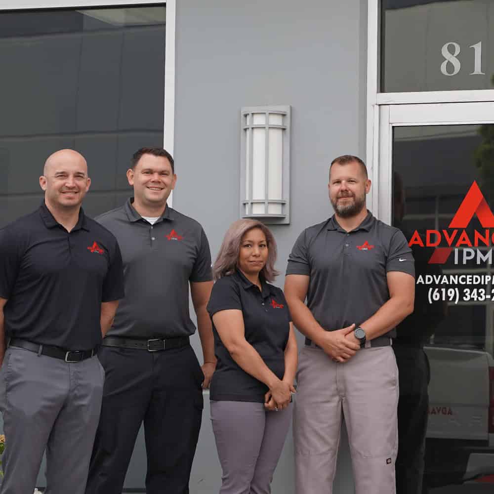 Staff Standing In Front of Office Signage