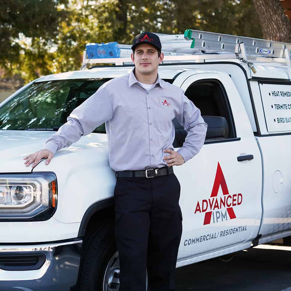 Advanced IPM Service Tech In Front of Truck